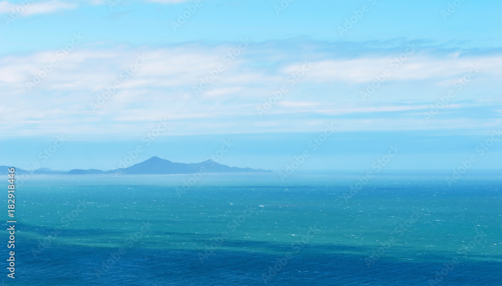 Mountains seen from distance in the horizon over the sea