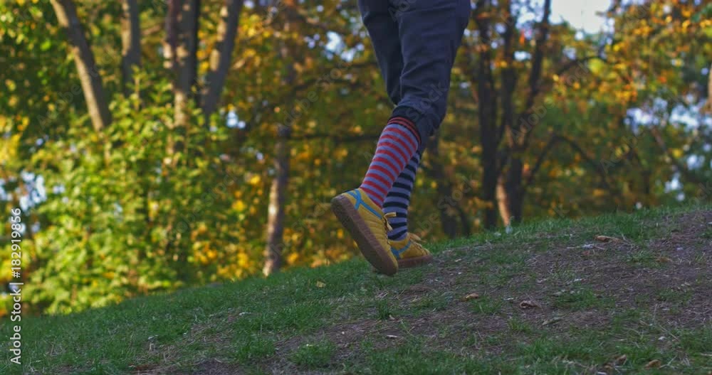 Girl with different socks climbing uphill Girl with different socks climbing uphill