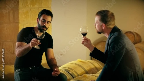 Man sommelier in wine tasting room talking with taster before purchase