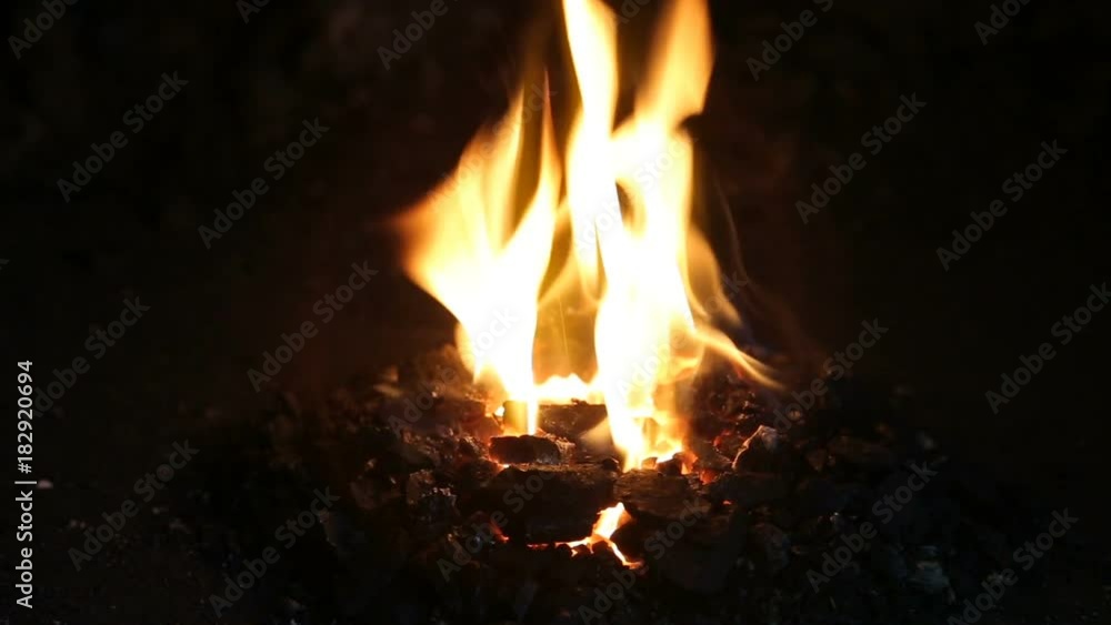 burning of coal in a blast furnace, heating of a metal rod. Blacksmiths oven, close-up. burning of coal in a blast furnace, heating of a metal rod. Blacksmiths oven, close-up.