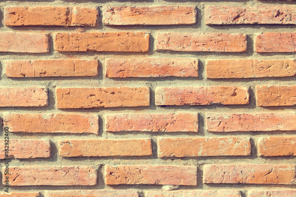 Obraz premium Old grunge brick wall background, Common sight in the local city. Use for design and texture. Vintage tone.