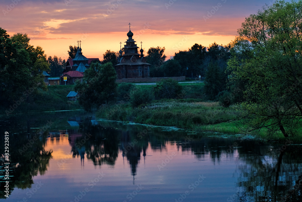 Wooden Orthodox church with reflection in river. The monument of wooden architecture of Russia.Suzdal. Golden Ring of Russia