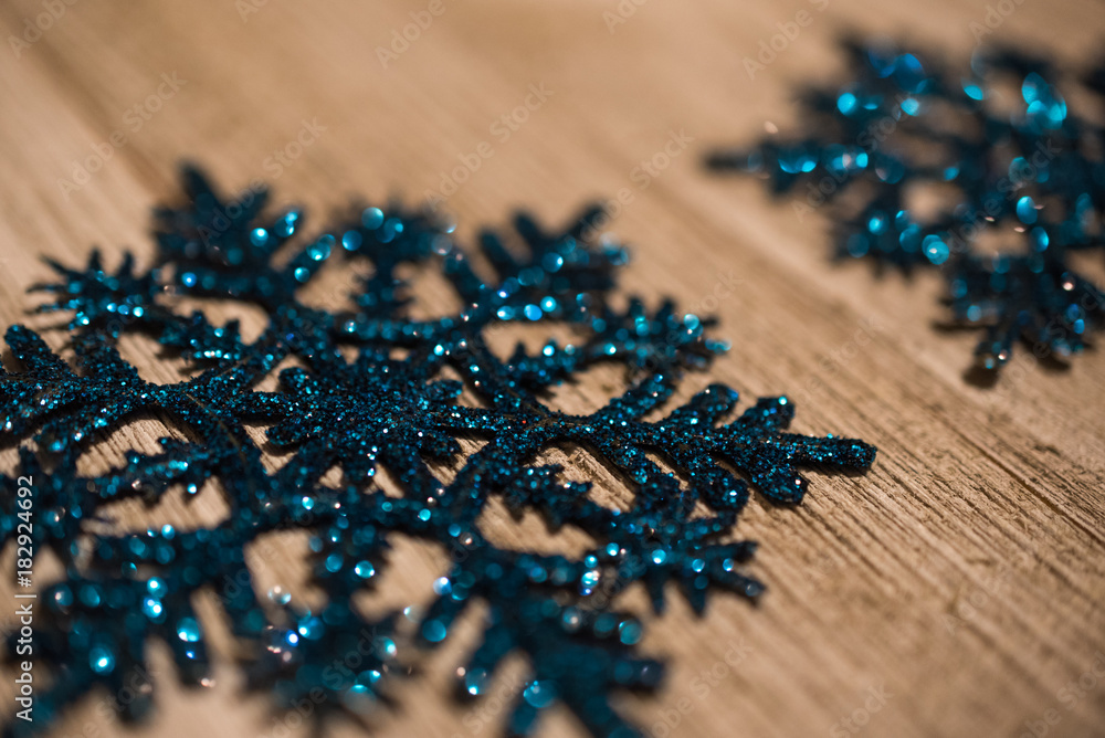 Selective focus on center of blue glitter snowflake Selective focus on center of blue glitter snowflake