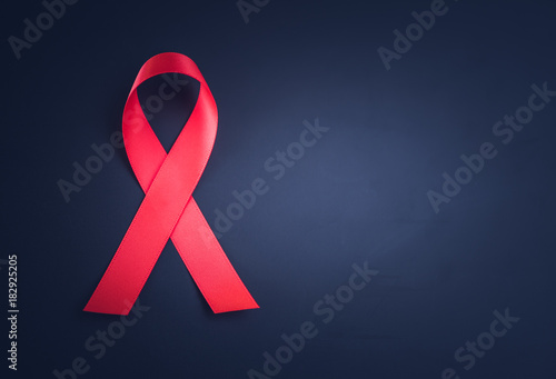 Red ribbon awareness on black background for World Aids day campaign.