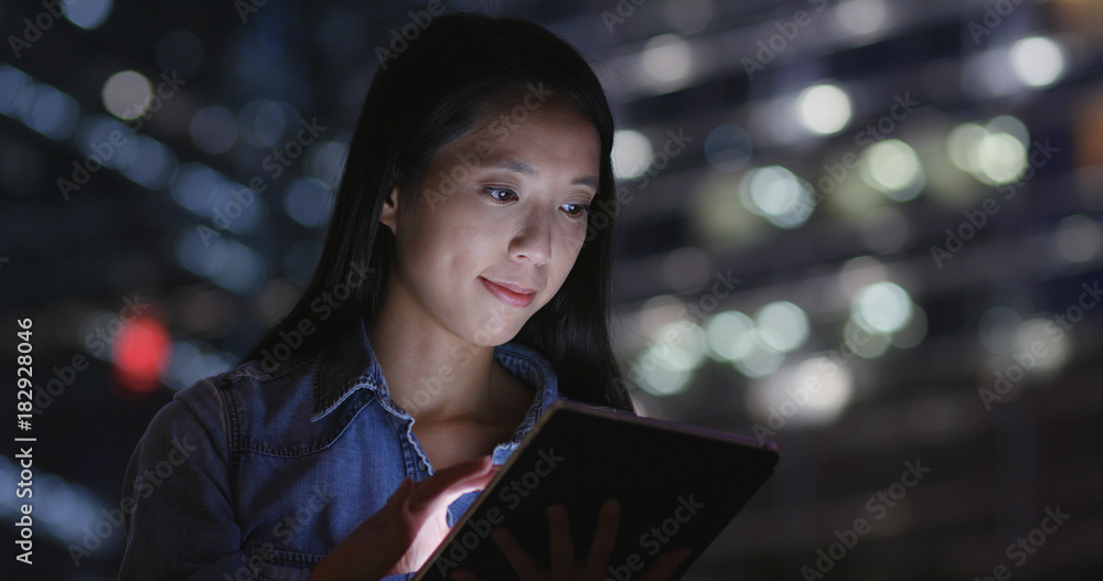 Woman use of digital tablet computer at night Woman use of digital tablet computer at night