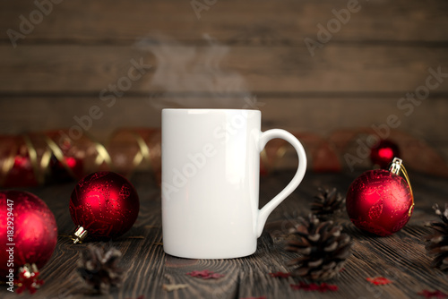 Christmas concept composition with a mug on a wooden table. © yvsedova