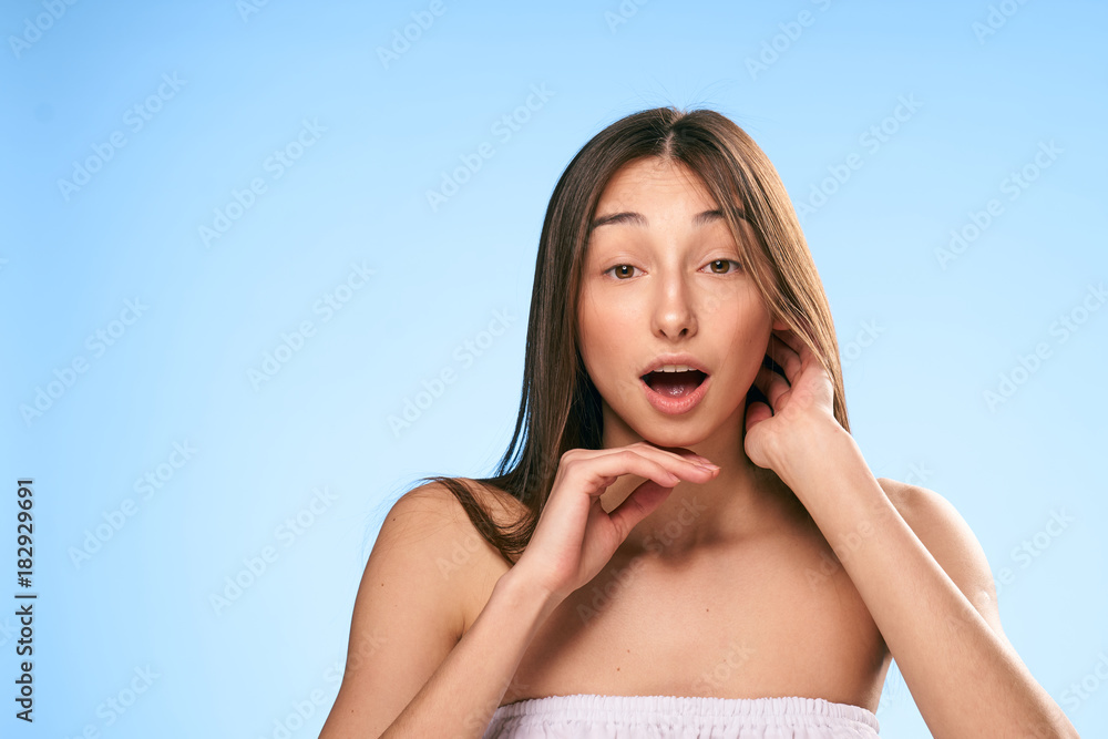 Young beautiful woman on a light blue background, portrait, emotions Young beautiful woman on a light blue background, portrait, emotions