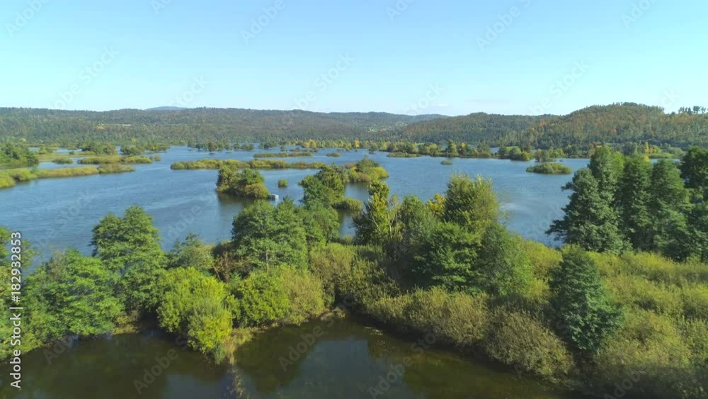 AERIAL: Abandoned submerged fields after heavy rainfall on sunny autumn afternoon. Extensive floods of countryside after storm destroyed rural fields and forests. Overflowing rivers ravaging nature. AERIAL: Abandoned submerged fields after heavy rainfall on sunny autumn afternoon. Extensive floods of countryside after storm destroyed rural fields and forests. Overflowing rivers ravaging nature.