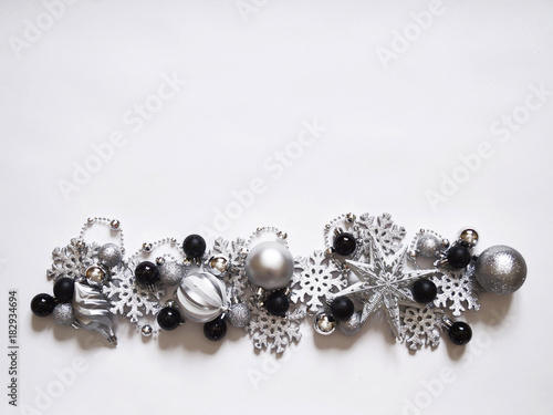 Christmas decoration with balls and snowflakes. View from above. Colors are black, gray, silver and white. New Year.