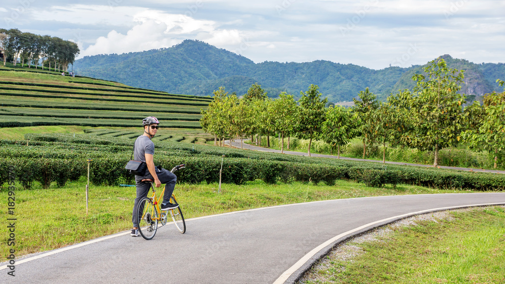 Naklejka premium Men riding a bicycle at Singha park Chiang Rai, Thailand.