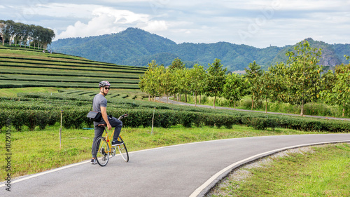 Men riding a bicycle at Singha park Chiang Rai, Thailand.
