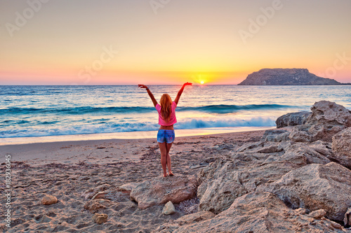 A woman at sunset in Fragolimnionas beach of Karpathos  Greece