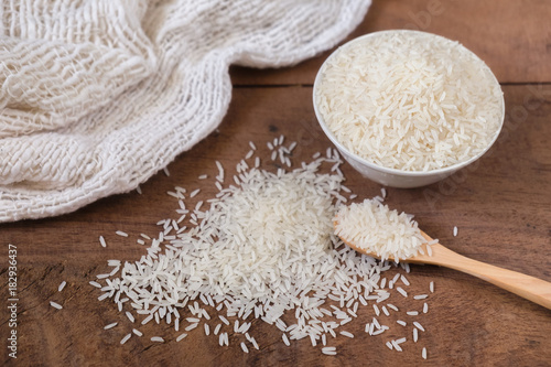 Organic rice, Jasmine rice with spoon on wooden table background