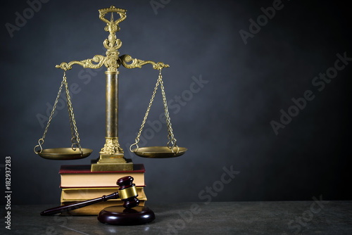 Golden scales of justice, gavel and books on brown background, Law code