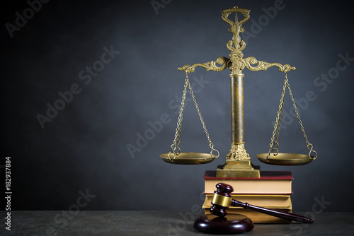 Golden scales of justice, gavel and books on brown background, Law code