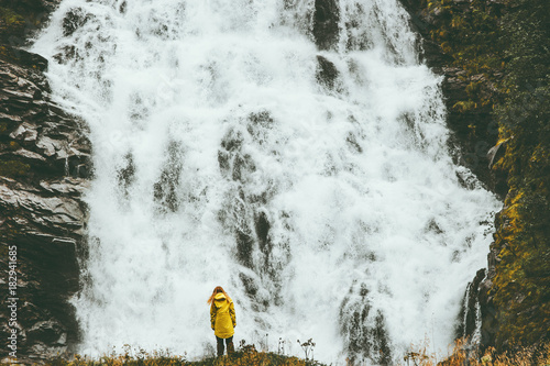 Woman enjoying big waterfall landscape view outdoor Travel Lifestyle concept adventure scandinavian vacations in Norway photo