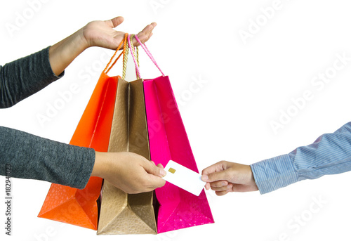 Customer paying for their order with a credit card in shopping mall. seller holding a shopping bag and returning the credit card for customer after payments