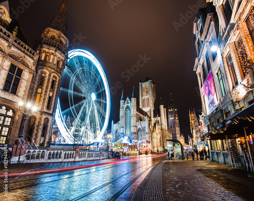 Obraz na płótnie Ghent, Belgium - January 3th, 2017. Gent city winter festival in Flanders. Christmas fair with ferris wheel, illumination and Xmas decorations near Saint Nicholas Church on the Ghent Old town square. w salonie