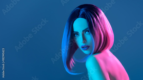 beautiful charming nude woman in pink wig, isolated on blue with pink filter