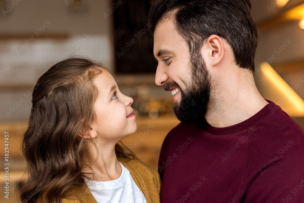 smiling daughter and father looking at each other in cafe smiling daughter and father looking at each other in cafe
