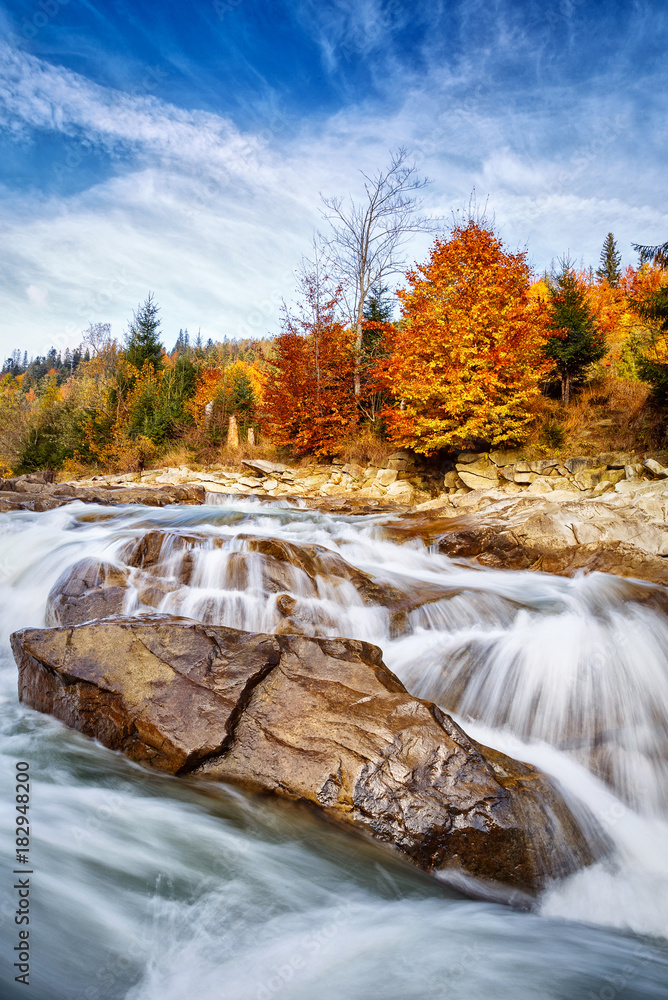 Fotografie Restless dangerous mountain river with stones