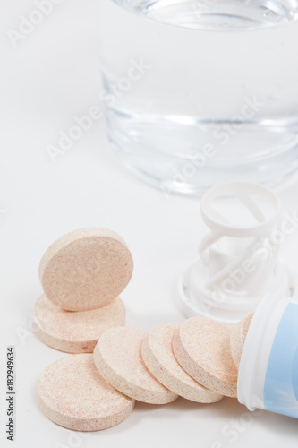 Fizzy tablet with packaging and glass of water