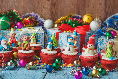 Christmas cupcakes with colored decorations made from confectionery mastic © lisssbetha