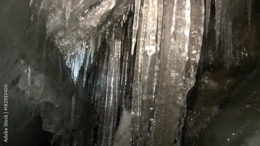 Icicles in cave Svalbard Arctic. Hollow place in in glacier. Eternal Frost. North Pole. Beautiful unique background. Ice desert landscape. Quiet of wilderness. Icicles in cave Svalbard Arctic. Hollow place in in glacier. Eternal Frost. North Pole. Beautiful unique background. Ice desert landscape. Quiet of wilderness.