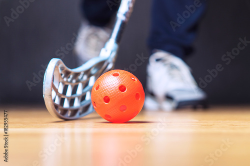 Floorball player with stick and ball. Floor hockey concept.
