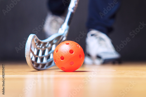 Fotografie Floorball player with stick and ball. Floor hockey concept.