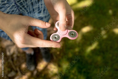 Girl playing with fidget spinner  photo