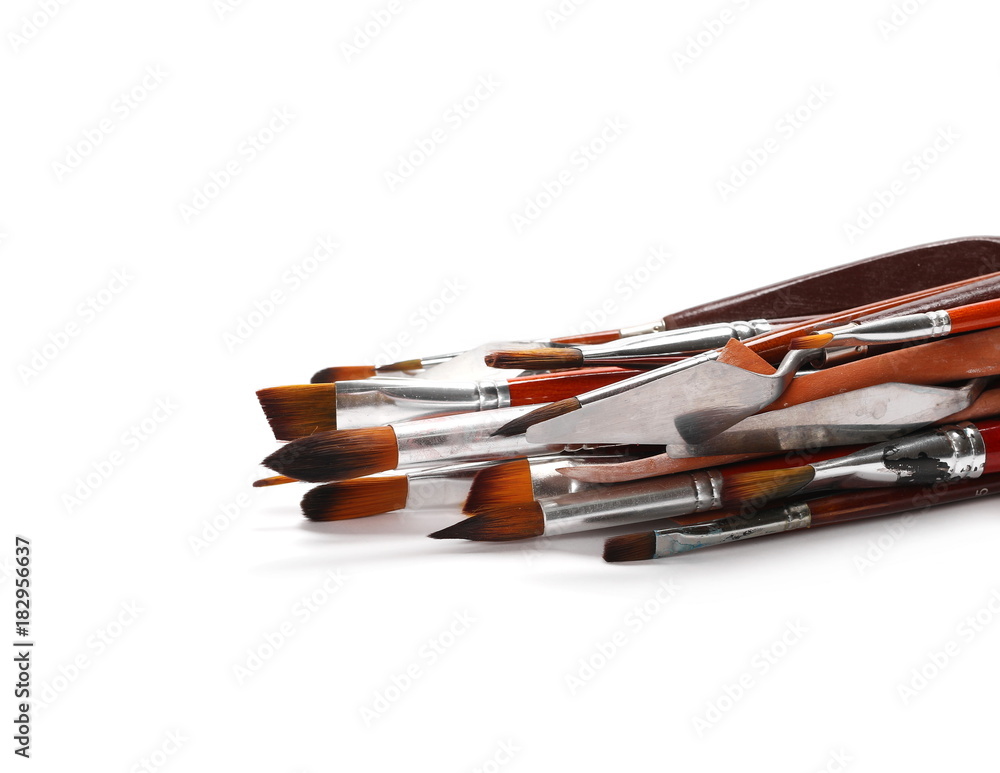 Set of various brushes and painting utensils isolated on white background
