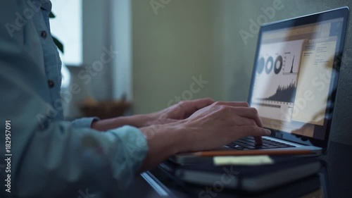 Young man using laptop at home. Freelancer working at home.