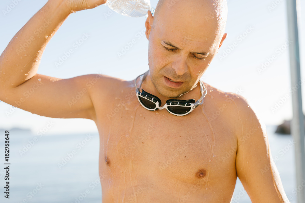 Man taking shower after swimming Stock Photo Adobe Stock