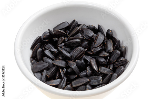 Sunflower seeds/ Sunflower seeds in a bowl on a white background