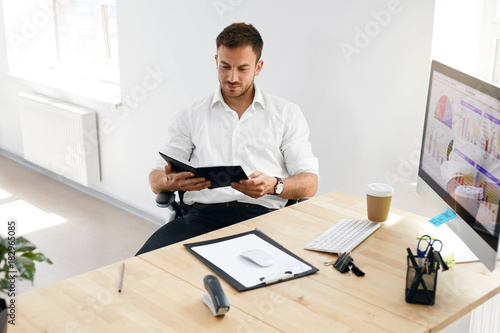 Young Business Man Working On Computer In Office.