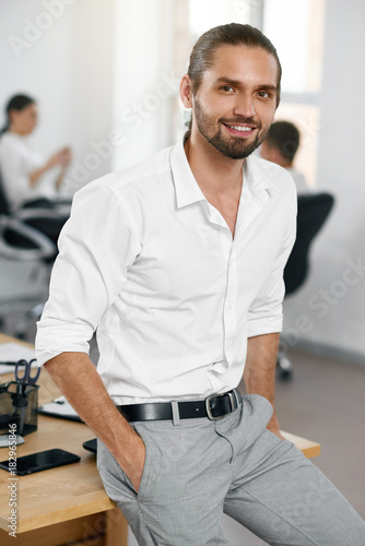 Confident Male Worker Standing In Office