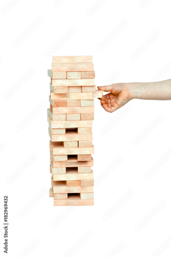 Kid Hand playing with the wood game (jenga). on white background. Kid Hand playing with the wood game (jenga). on white background.