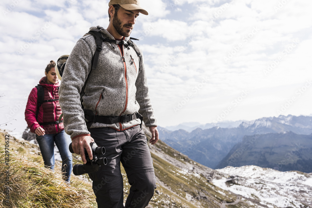 Hikers walking in mountain landscape Hikers walking in mountain landscape