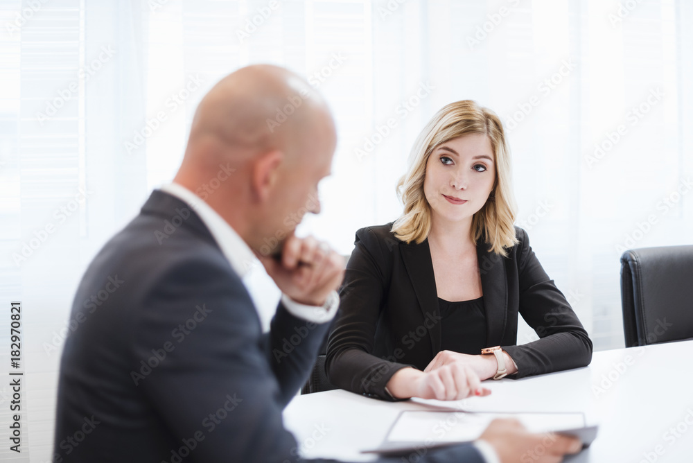 Businessman and businesswoman in conference room Businessman and businesswoman in conference room