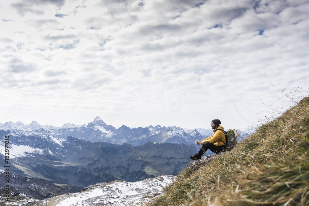 Germany, Bavaria, Oberstdorf, hiker sitting in alpine scenery Germany, Bavaria, Oberstdorf, hiker sitting in alpine scenery