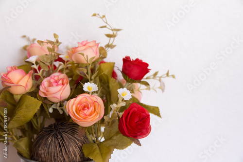Beautiful romantic flower bouquet of orange and red roses with white copy space background.