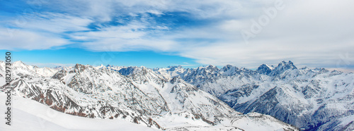 Mountains in snow. Panorama of winter landscape with peaks and blue sky © Pavlo Vakhrushev