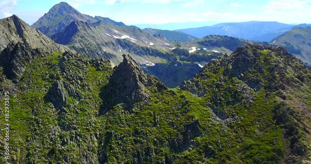 Beehive Basin Montana - Drone Aerial View Of Rocky Ridgeline With Steep Slopes Covered In Green Foliage Beehive Basin Montana - Drone Aerial View Of Rocky Ridgeline With Steep Slopes Covered In Green Foliage
