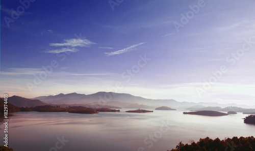 beautiful landscape with the sea in the purple sunset tones and the mountains in the distance
