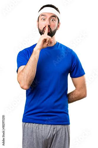 Funny sportsman making silence gesture on isolated white background