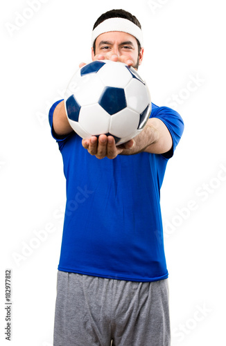 Funny sportsman holding a soccer ball on isolated white background