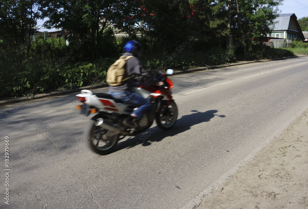 A motorcyclist rides on the road