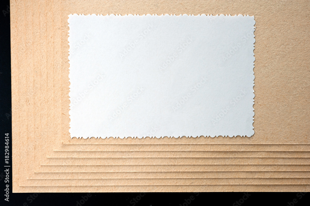 Sheet of paper and rough, textured cardboard