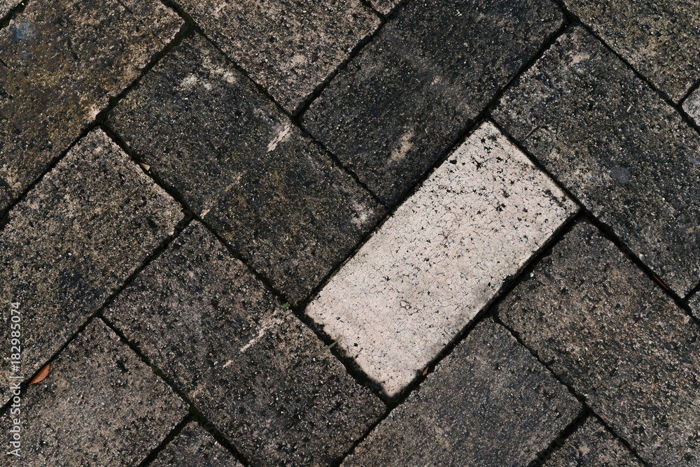 White brick stand out of others darker brick White brick stand out of others darker brick